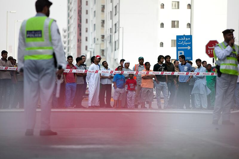 Abu Dhabi, United Arab Emirates, May 7, 2013: 
Passersby look on as emergency units finish up working on a fire, which seems to have gutted an apartment on a third floor of an older building on Airport Road near 13th Street in Abu Dhabi on Tuesday late afternoon, May 7, 2013.
Silvia Razgova / The National

