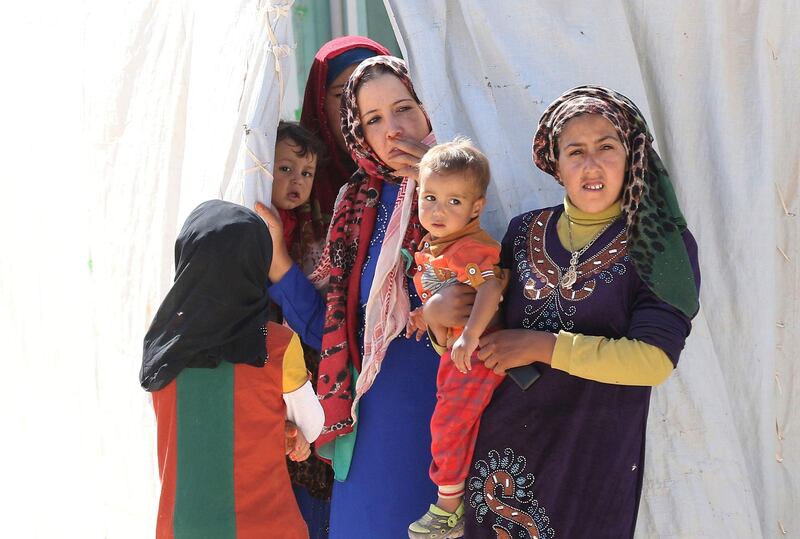 Syrian refugees stand at the Zaatari refugee camp, located close to the northern Jordanian city of Mafraq near the border with Syria, on July 14, 2016.
Zaatari camp, 80 kilometres (50 miles) north of the capital Amman, is home to some 80,000 refugees from the brutal war in neighbouring Syria. 


 / AFP PHOTO / KHALIL MAZRAAWI