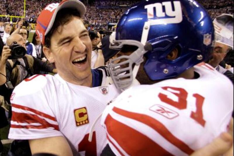 New York Giants quarterback Eli Manning, left, and Aaron Ross celebrate their team's 21-17 win over the New England Patriots in the NFL Super Bowl XLVI football game, Sunday, Feb. 5, 2012, in Indianapolis. (AP Photo/Eric Gay) *** Local Caption ***  Super Bowl Football.JPEG-0192f.jpg