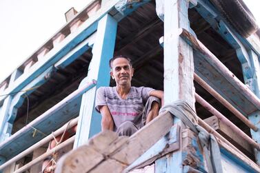 DUBAI, UNITED ARAB EMIRATES - JULY 10 2019. Dhow captain Abdulredha Mohammed from Kish Island. For many people, the creek (Khor) with its dhow moorings, abra water taxis, and souks is the very essence of the old city - the place where many things have started. For decades, Dubai Creek has been a hub of activity as traders bring in goods and sell their wares at the bustling markets nearby. Photo by Reem Mohammed/The National) Reporter: JOHN DENNEHY Section: