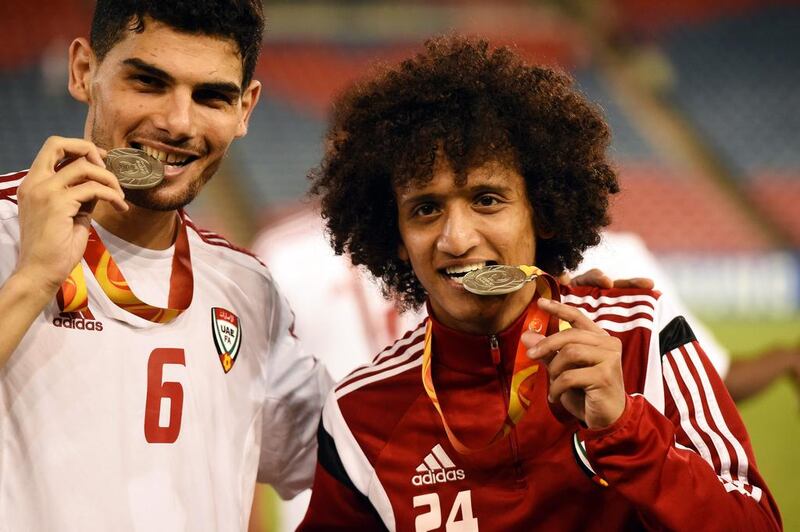 UAE players Mohanad Salem, left, and Omar Abdulrahman pose for photographers with their bronze medals after winning the 2015 Asian Cup third place match. Dean Lewins / EPA / January 10, 2015