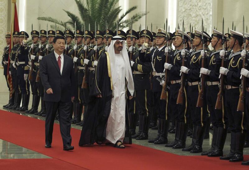 Sheikh Mohammed bin Zayed and Xi Jinping inspect a guard of honour in China in 2012. Reuters