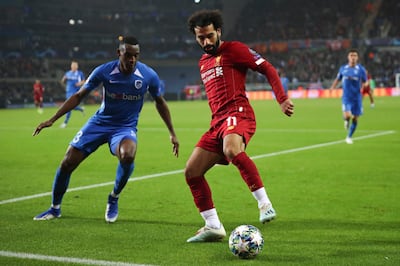 Liverpool's Mohamed Salah, right, vies for the ball with Genk's Jhon Lucumi during a Champions League group E soccer match between Genk and Liverpool at the KRC Genk Arena in Genk, Belgium, Wednesday, Oct. 23, 2019. Salah scored once in Liverpool's 4-1 victory. (AP Photo/Francisco Seco)