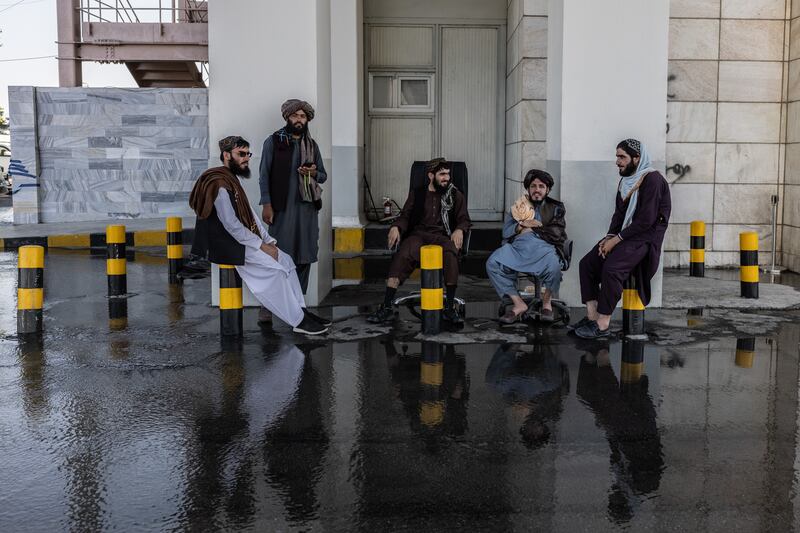 Taliban members at the airport. Outside the gates, fighters set up security checkpoints, but so far only male arrivals undergo body and bag searches. Stefanie Glinski for The National