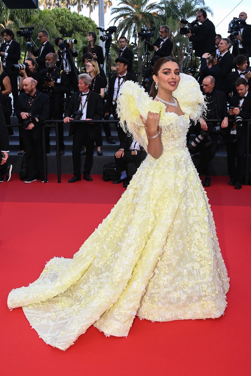Saudi influencer Eleen Suliman in a yellow Michael Cinco gown on the closing night of Cannes 2022 on May 28. Getty Images