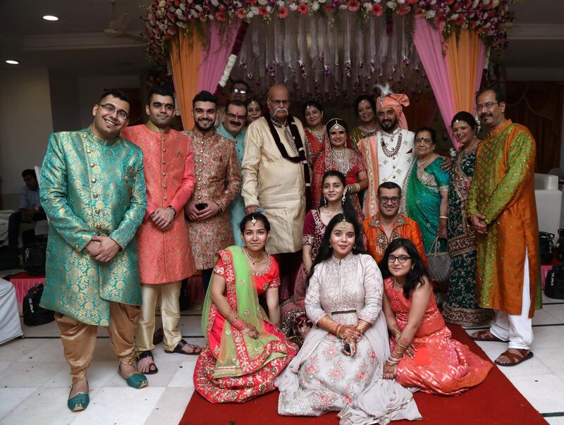 Kishan Gandhi and his wife Lata on either side of the bride and groom during their granddaughter’s wedding in January last year. The elderly couple died of Covid-19 within a space of two days in January. They lived in the UAE since the early 1960s and raised two generations who call the country their home. Courtesy: Gandhi family 