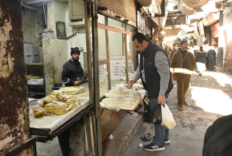 epa09040994 Syrians shopping for their basic daily needs at one on the traditional markets in Damascus, Syria, on 27 February 2021, as prices have lately skyrocketed in light of the tightened US sanctions and international siege imposed on this war-torn country.  EPA/YOUSSEF BADAWI