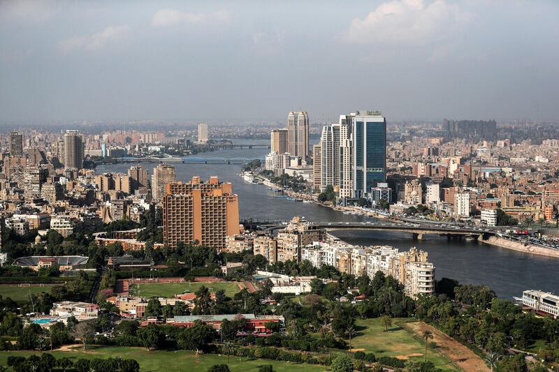 This picture taken on October 23, 2019 from the Cairo Tower in the centre of the Egyptian capital shows a view of the Nile river flowing through the city between the central downtown (R) and Zamalek (L) districts. (Photo by Mohamed el-Shahed / AFP)