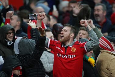 Manchester United fans celebrate their 2-0 win over Manchester City in the Premier League on Sunday. Reuters