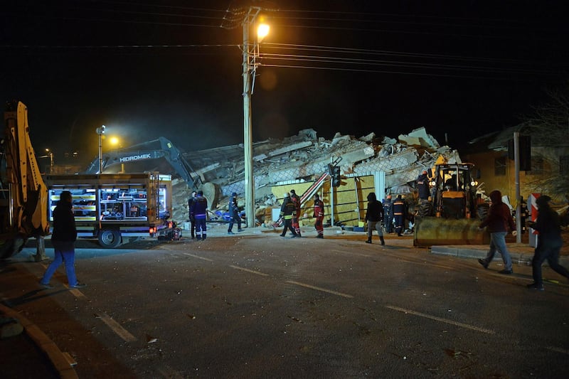 Turkish officials and police work at the scene of a collapsed building following a 6.8 magnitude earthquake in Elazig, eastern Turkey.  AFP