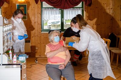 NAUMBURG, GERMANY - MARCH 01: Nurse Susann Wolter (R) vaccinates Renate Bauer (C), 82, with the Pfizer-BioNTech vaccine in an old clubhouse during the novel coronavirus pandemic in Seidewitz on March 1, 2021 near Naumburg, Germany. So far approximately 4.4% of Germany's population has received the first dose of a Covid-19 vaccine. (Photo by Jens Schlueter/Getty Images)