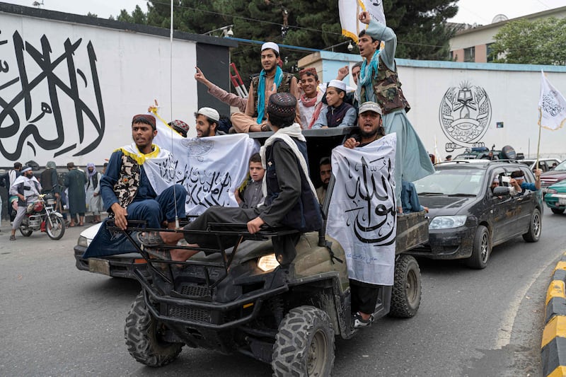 Taliban fighters ride in a convoy near the US embassy in Kabul. AFP