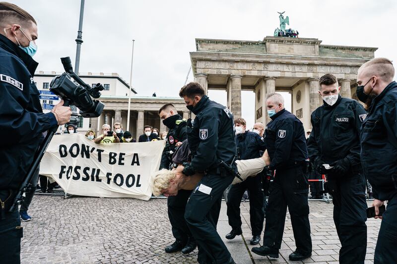 Police detain an activist as Extinction Rebellion demonstrate in front of the Brandenburg Gate in Berlin, Germany.  Climate change protests and blockades have been taking place in the German Capital since August 16. EPA