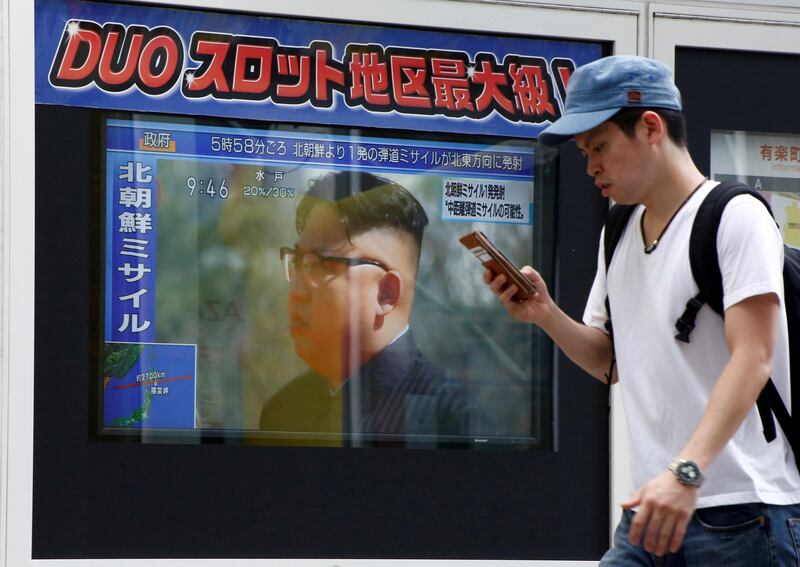 A man walks past a TV set showing North Korea's leader Kim Jong-Un in a news report about North Korea's missile launch in Tokyo, Japan, August 29, 2017. Kim Kyung-Hoon / Reuters