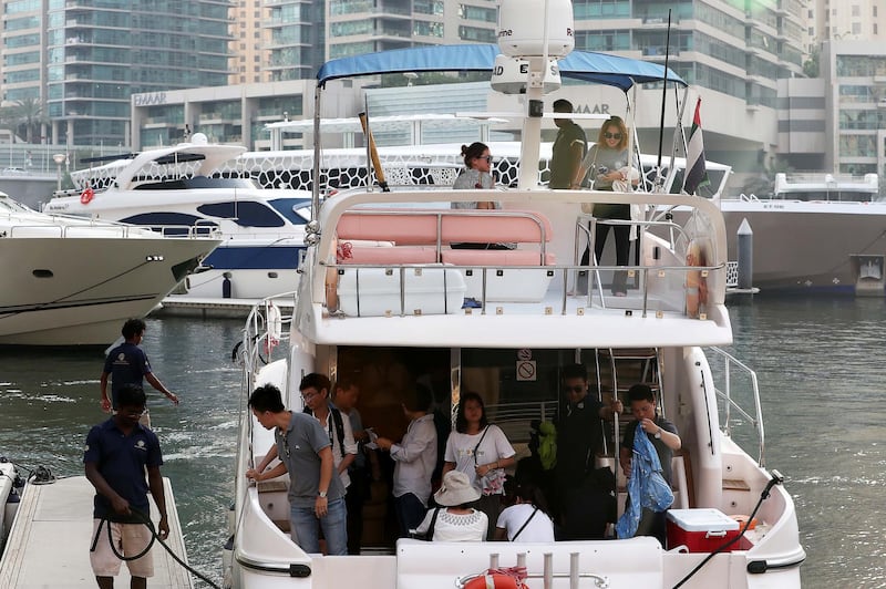 DUBAI , UNITED ARAB EMIRATES , JUNE 03 – 2018 :- Tourists after taking the yacht ride at Dubai Marina in Dubai.  ( Pawan Singh / The National )  For News.