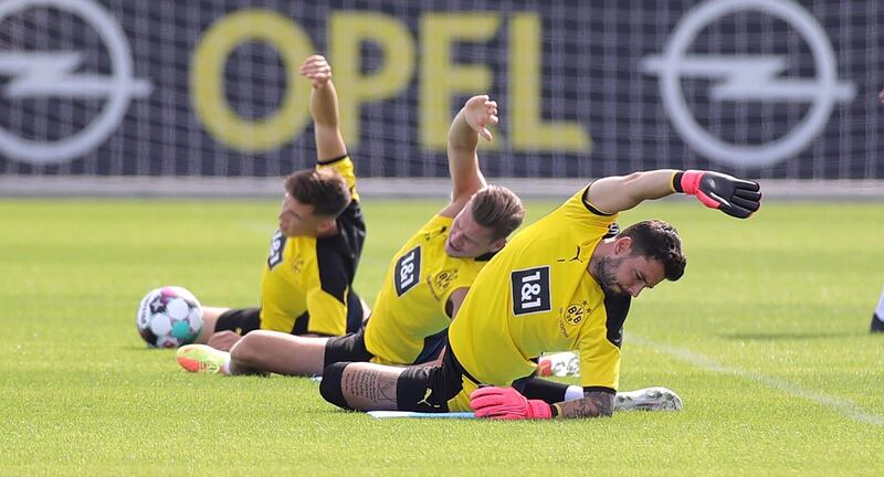 Borussia Dortmund's goalkeeper Roman Buerki, right, warms up during the team's first pre-season training session in Dortmund on Monday. EPA