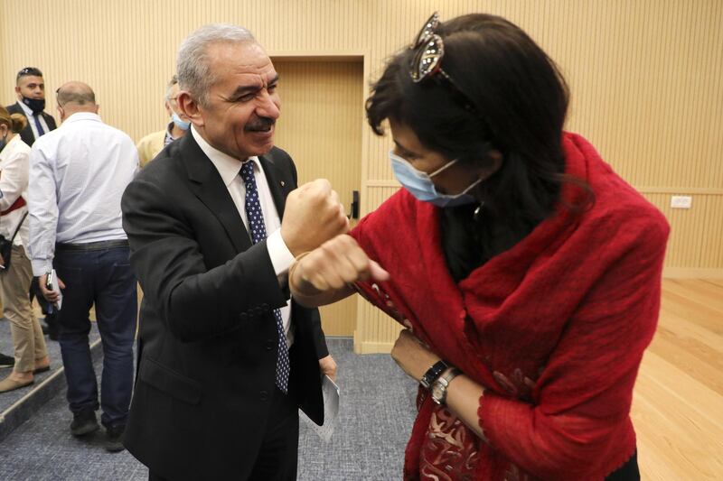 Palestinian Prime Minister Mohammad Shtayyeh greets a journalist with an elbow bump following a meeting with members of the Foreign Press Association in Ramallah, in the Israeli-occupied West Bank. Reuters