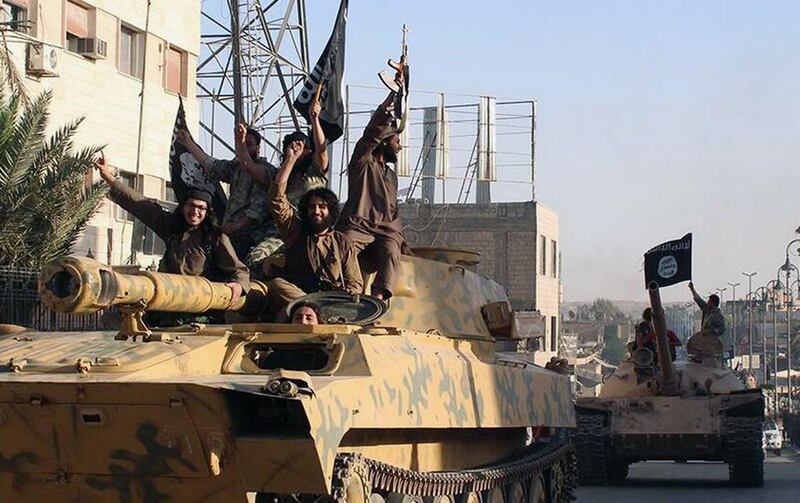 ISIL fighters parade through the Syrian city of Raqqa  (AP Photo/Raqqa Media Center)