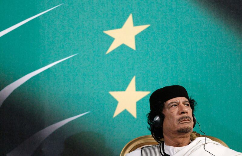Libyan leader Muammar Gaddafi looks on as Italy's Prime Minister Silvio Berlusconi gives a speech in Rome in this August 30, 2010 file photo. Gaddafi died of wounds suffered in his capture near his hometown of Sirte on October 20, 2011, a senior NTC military official said. National Transitional Council official Abdel Majid Mlegta told Reuters earlier that Gaddafi was captured and wounded in both legs at dawn on Thursday as he tried to flee in a convoy which NATO warplanes attacked.  REUTERS/Max Rossi/Files (ITALY - Tags: POLITICS) *** Local Caption ***  SIN301_LIBYA-_1020_11.JPG