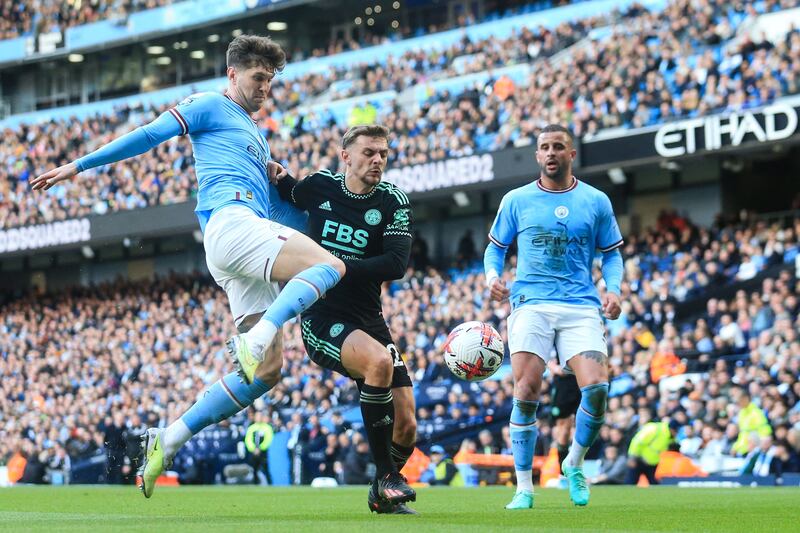 Manchester City's John Stones, left, fights for the ball with Leicester City's Kiernan Dewsbury-Hall. AFP