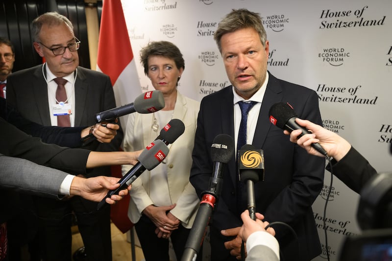 German Vice Chancellor Robert Habeck, right, with Swiss ministers Simonetta Sommaruga and Guy Parmelin after a meeting held on the sidelines of the summit. EPA