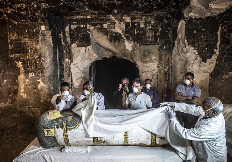 Egypt's Antiquities Minister Khaled el-Enany (right) and Mostafa Waziri (second right, behind), the Secretary General of the Supreme Council of Antiquities, inspect an intact sarcophagus during its opening at the site of Tomb TT33 at Al-Assasif necropolis on the west bank of the Nile north of the southern Egyptian city of Luxor. AFP