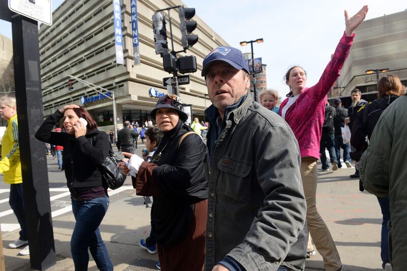 BOSTON, MA - APRIL 15: People look on at the corner of Stuart and Dartmouth St., near the finish line after two bombs exploded during the 117th Boston Marathon on April 15, 2013 in Boston, Massachusetts. Two people are confirmed dead and at least 28 injured after at least two explosions went off near the finish line to the marathon.   Darren McCollester /Getty Images/AFP== FOR NEWSPAPERS, INTERNET, TELCOS & TELEVISION USE ONLY ==
 *** Local Caption ***  917863-01-09.jpg