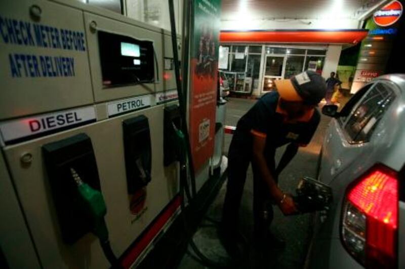 A worker fills petrol in a car at a fuel station in Jammu May 14, 2011. State-run oil firms will raise petrol prices by about 8.6 percent or 5 rupees a litre from Sunday, company officials said on Saturday, a record hike that will fuel inflation in Asia's third-largest economy. REUTERS/Mukesh Gupta (INDIAN-ADMINISTERED KASHMIR - Tags: BUSINESS ENERGY) *** Local Caption ***  DEL02_INDIA-_0514_11.JPG