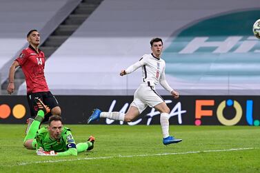 TIRANA, ALBANIA - MARCH 28: Mason Mount of England scores their side's second goal past Etrit Berisha of Albania during the FIFA World Cup 2022 Qatar qualifying match between Albania and England at the Qemal Stafa Stadium on March 28, 2021 in Tirana, Albania. Sporting stadiums around Europe remain under strict restrictions due to the Coronavirus Pandemic as Government social distancing laws prohibit fans inside venues resulting in games being played behind closed doors. (Photo by Mattia Ozbot/Getty Images)