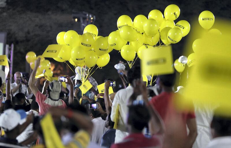 DUBAI , UNITED ARAB EMIRATES, September 27 , 2018 :- Workers holding the balloons and flags during the DU  & Western Union Camp Ka Champ held at Nuzul Accommodation in Jabel Ali Industrial area in Dubai. ( Pawan Singh / The National )  For News/Big Picture/Instagram/Online. Story by Patrick