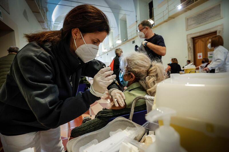 Health workers administer booster shots at San Giovanni Addolorata Hospital in Rome, Italy. EPA