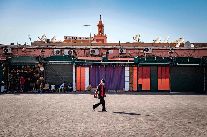 A man walks by mostly-closed stalls at the Jemaa El Fna square in Marrakesh, Morocco. AFP
