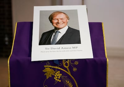 A picture of David Amess displayed near the altar in St Peters Catholic Church before a vigil in Leigh-on-Sea, Essex after his murder. AP