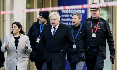 Former City of London commissioner Ian Dyson (R) - with Boris Johnson and Priti Patel in 2019 - believes a local approach to fraud has been overlooked. Getty Images