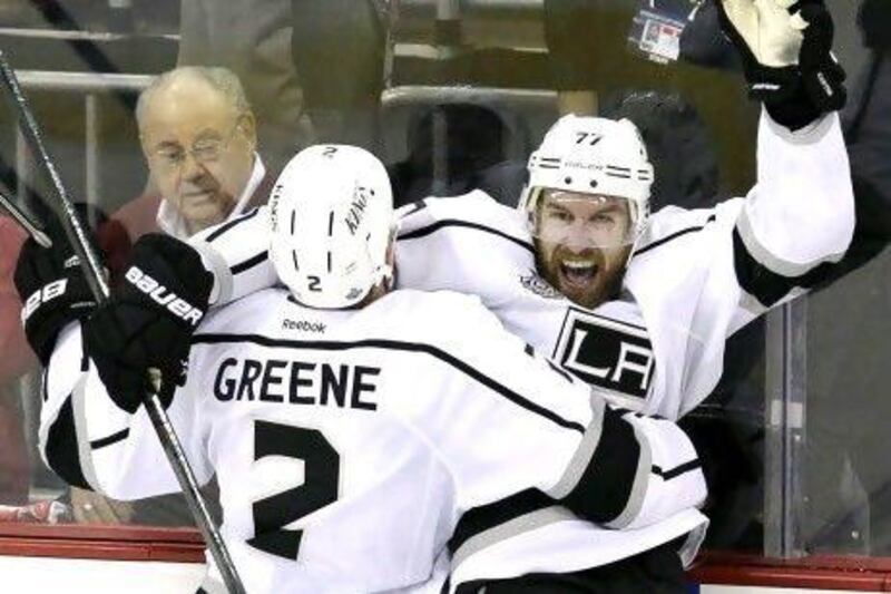 Los Angeles Kings' Jeff Carter, top right, celebrates with teammate Matt Greene after scoring the game-winning goal against the New Jersey Devils during the overtime period of Game 2 of the Stanley Cup finals.