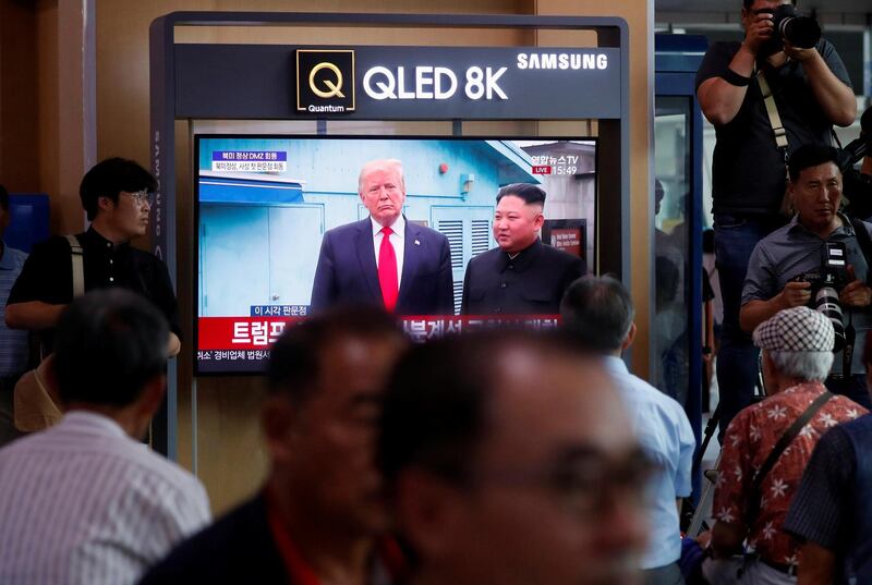 South Koreans watch a television broadcasting news of the event. EPA