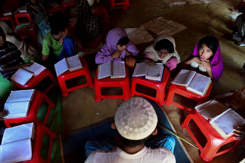 Rohingya refugee children read the quran in a mosque at Kutupalong refugee camp in Bangladesh's Ukhia district. Munir Uz Zaman / AFP