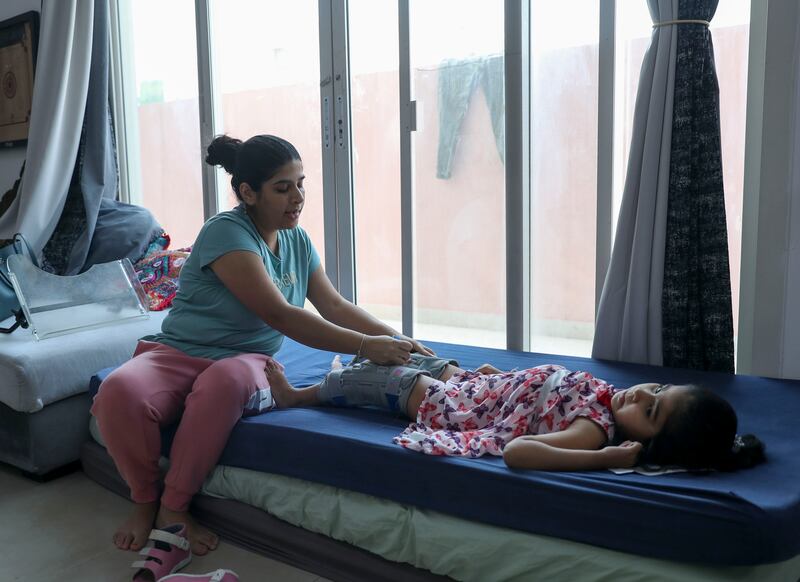 Astha Muthoo, 35, left her career and job to take care full-time of Arya, 6, who has spinal muscular atrophy, in Abu Dhabi. Khushnum Bhandari / The National