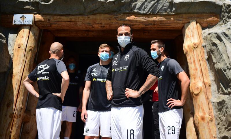 Dennis Diekmeier and Ivan Paurevic of SV Sandhausen wear medical face masks prior to the Second Bundesliga match between FC Erzgebirge Aue and SV Sandhausen at Erzgebirgsstadion on May 16, 2020 in Aue, Germany. Getty