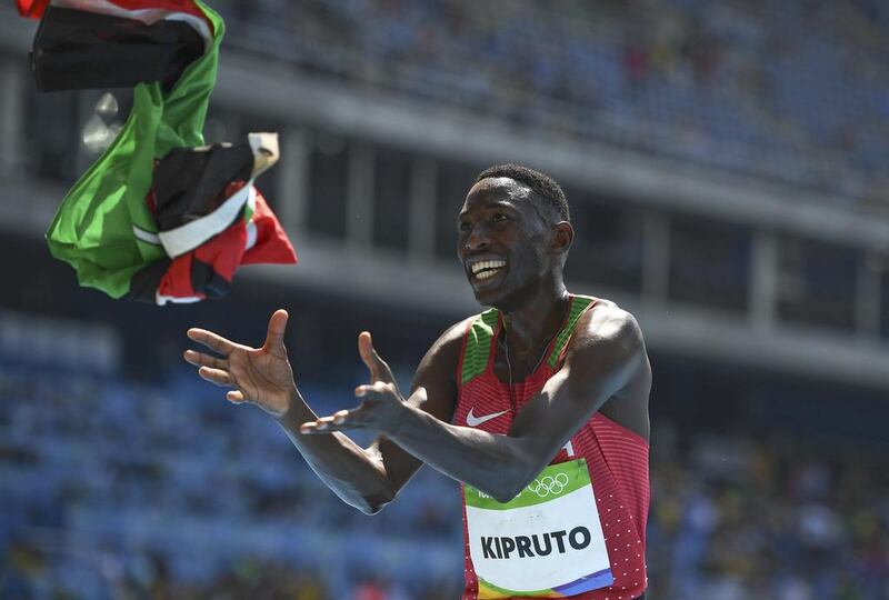 Conseslus Kipruto of Kenya catches flag to celebrate his 3000m steeplechase victory. Dylan Martinez / Reuters