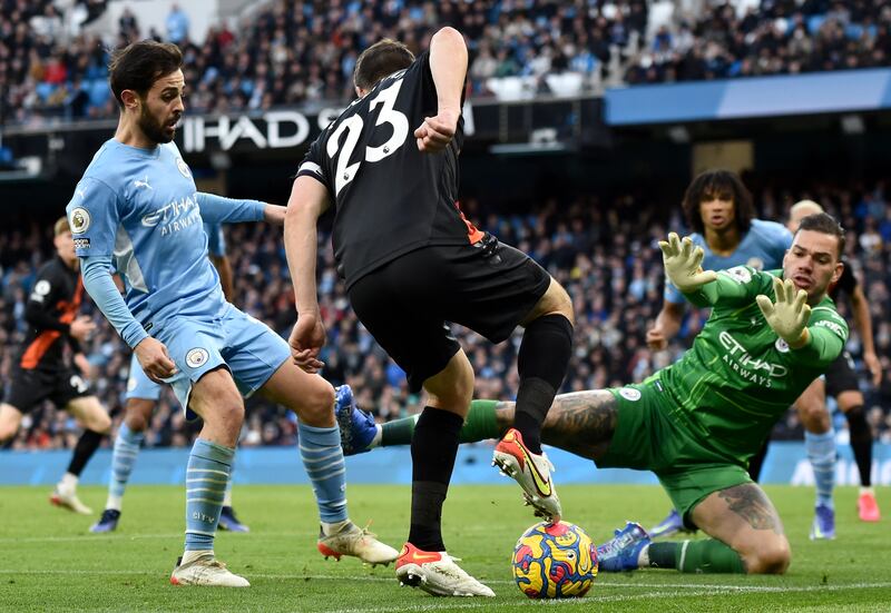 Seamus Coleman of Everton sees his shot blocked by Manchester City goalkeeper Ederson. EPA