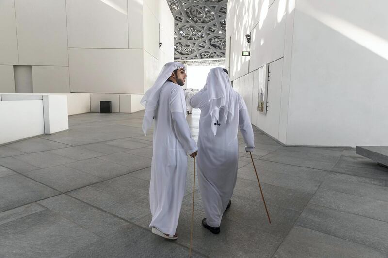ABU DHABI, UNITED ARAB EMIRATES. 01 DECEMBER 2018. BIGPICTURE OPTION. UAE National Day Program at the Louvre Abu Dhabi. Two Emirati Al Ayyala dancers walk with their canes. (Photo: Antonie Robertson/The National) Journalist: None. Section: National.