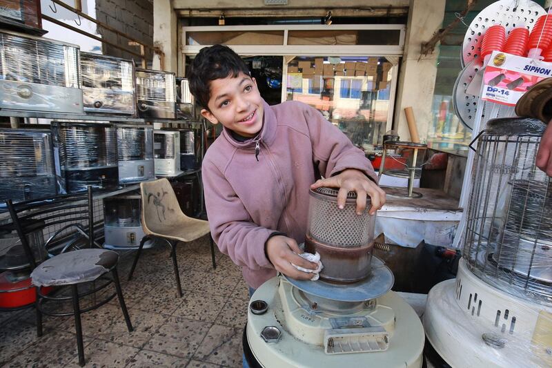Jordanian teenager, Omar, 14, fixes a kerosene heater in a workshop where he works in Amman. Many minors have been forced prematurely into the labour market in Jordan due to the Covid-19 pandemic, experts say. Schools in Amman and throughout the country have been closed for nearly a year now, while economic fallout from the pandemic has eaten into breadwinners' ability to feed their families. AFP