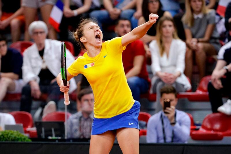 Romania's Simona Halep celebrates after winning against  France's Caroline Garcia in the third rubber of the Fed Cup tennis semi-final match between France and Romania at The Kindarena in Rouen on April 21, 2019. / AFP / Geoffroy VAN DER HASSELT
