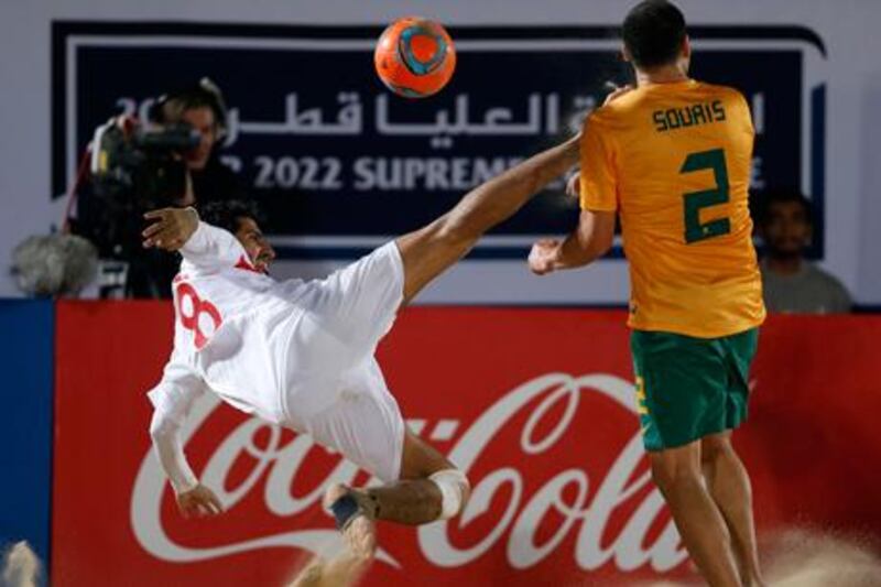 The UAE's Rami Abdulla Al Massabi reaches for the ball against Australia's George Souris during their Beach Soccer World Cup qualifying match in Doha.