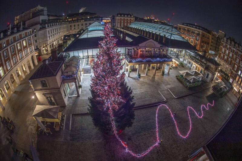 Late on Sunday evening, staff at Covent Garden in London wrapped its 16.7-metre Christmas tree in 30,000 lights and 200 baubles in preparation for the switching on of the lights to mark the start of the festive season. PA