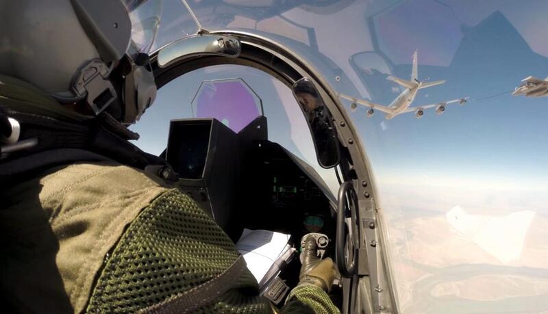 A photo provided by the French Army on September 19, 2014, shows a pilot navigating his Rafale fighter jet for a mid-air refuelling en route to Iraq. EPA