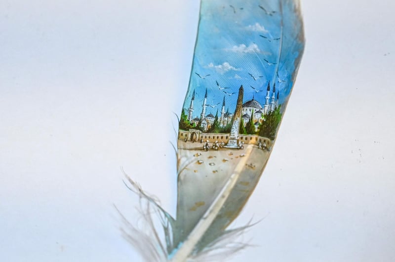 A mosque painted on a bird feather by Turkey's micro artist Hasan Kale in Istanbul. Photo: AFP