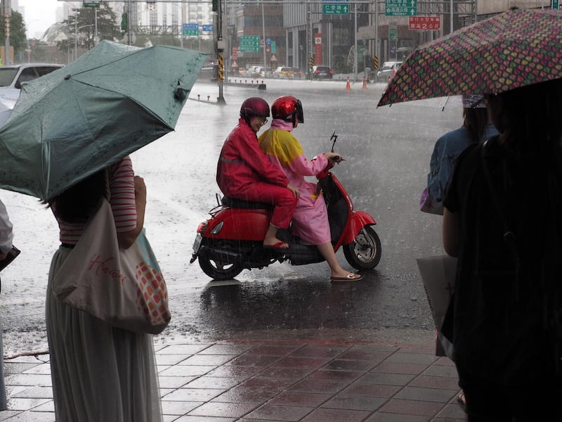 People waiting to cross the street under the rain in Taipei, Taiwan. According to The Central Weather Bureau, Typhoon Mitag is expected to bring strong wind and heavy rain to Taiwan between 30 September and 01 October, as it skirts Taiwan's east coast.  EPA