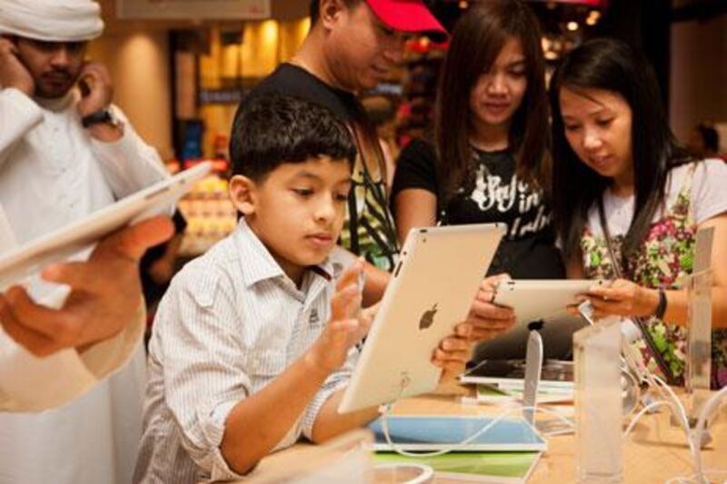 Youngsters check out the new iPad 2 at the Virgin MegaStore, Mall of the Emirates, in Dubai.